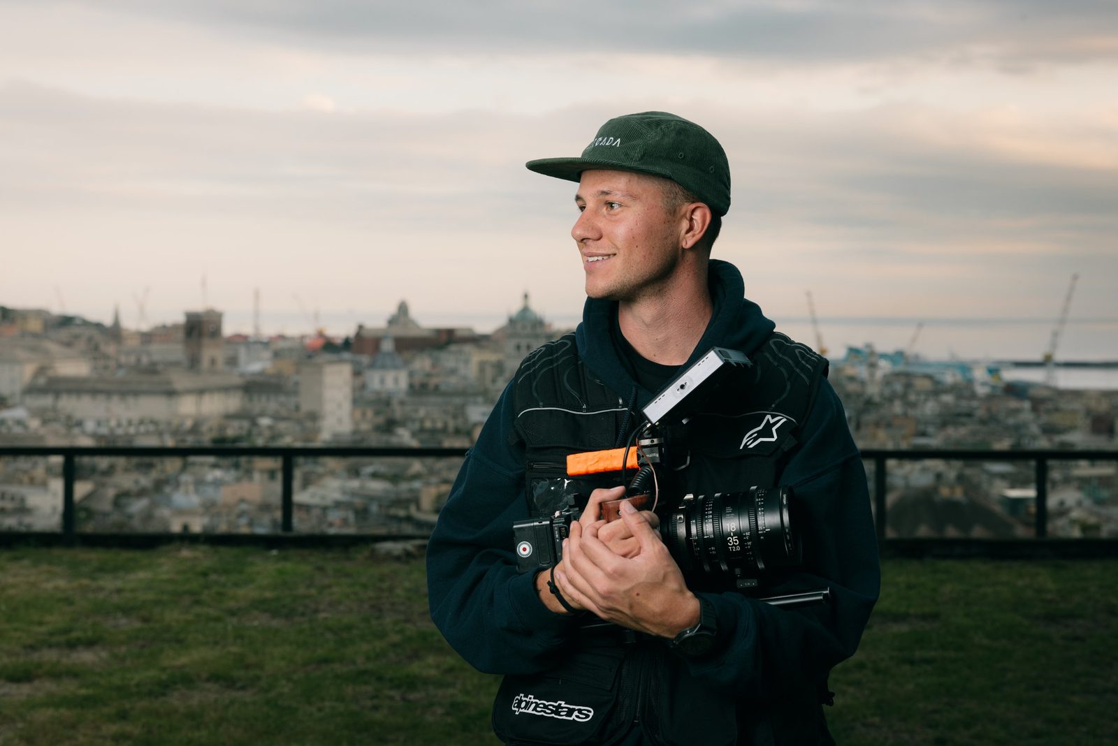 Mattia Baruffaldi with a cinema camera, the rooftops of Genoa behind him