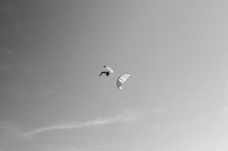 A kite high against an overcast sky