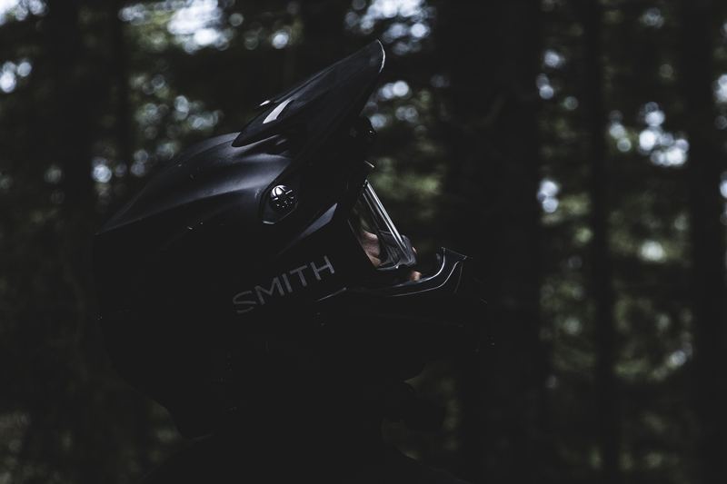 A goggle and helmet resting in low light