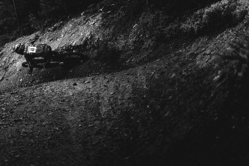 A rider carving a dusty hillside trail