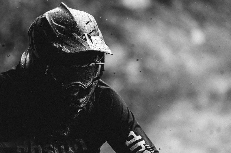 A mud-covered rider cornering hard