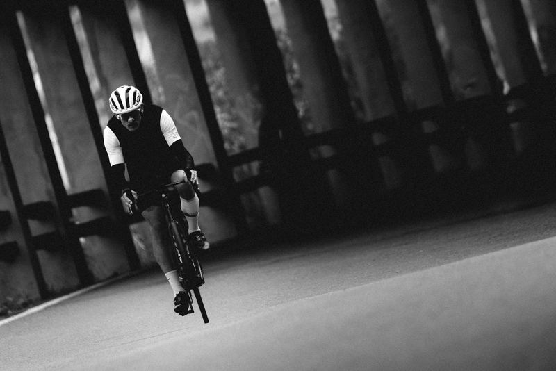 A road cyclist climbing through a snow gallery