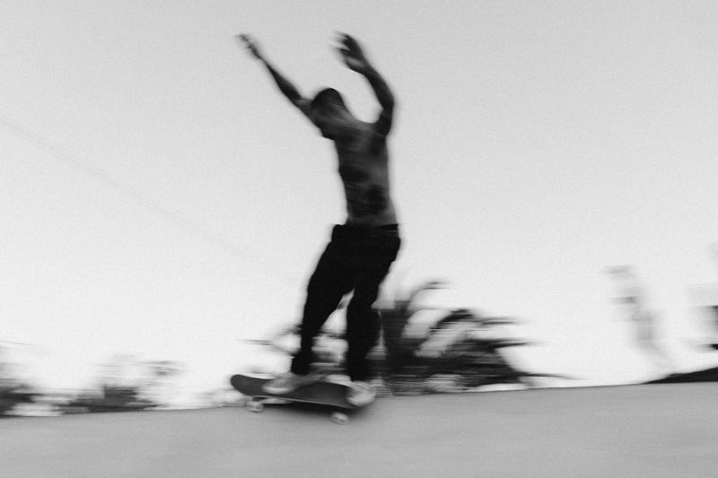 A skater riding out of a trick with both arms up
