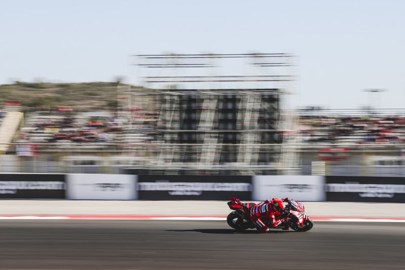 A race bike panned past the grandstands at speed
