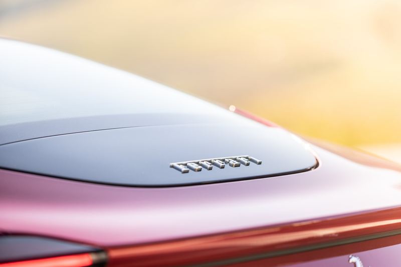 The rear deck of a Ferrari under pastel light