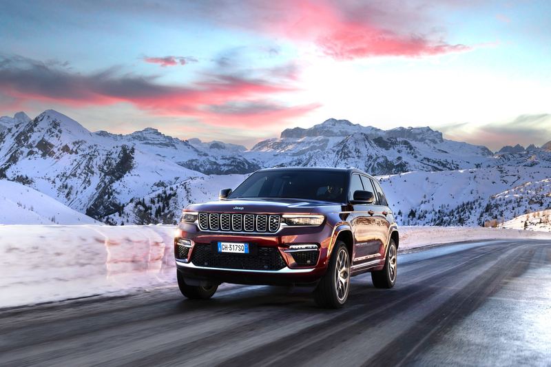 A Jeep Grand Cherokee crossing a snow-covered pass