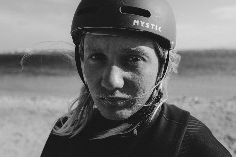 A woman in a water helmet looking into the lens